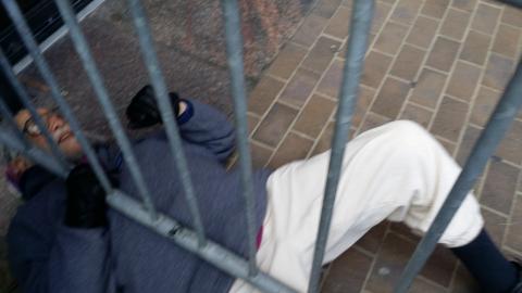 Reb Arthur seeking arrest at Phila Federal Bldg in protest of Tar sands Pipeline. Unable to clamber over barricades, he rolled under.